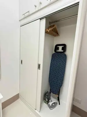 a walk in closet with a door open with a treadmill at Condo in Shore 3 Residences, Pasay in Manila