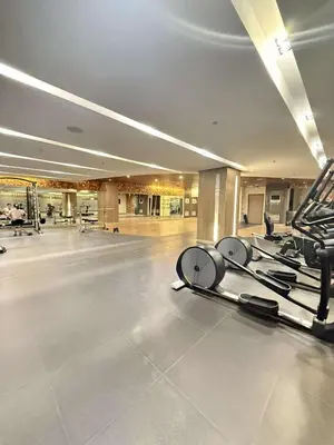 a gym with several treadmills in a large room at Condo in Shore 3 Residences, Pasay in Manila
