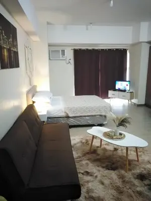 a living room with a couch and a table at Venice Mall Area Mckinley Hills Taguig in Manila