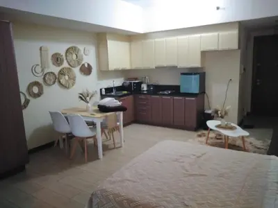a room with a kitchen and a table and chairs at Venice Mall Area Mckinley Hills Taguig in Manila