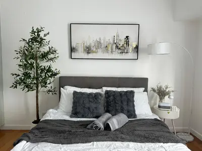 a bedroom with a bed with a picture on the wall at zuvyph in Manila