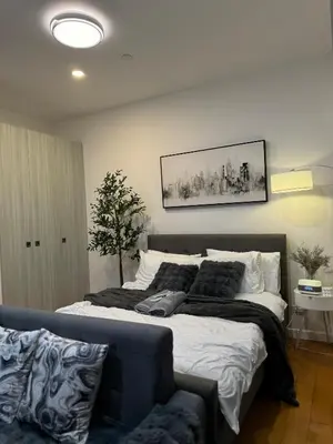 a bedroom with a large bed and a couch at zuvyph in Manila