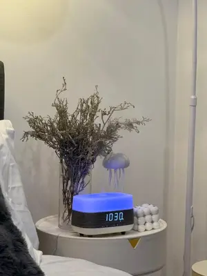 a table with a clock and a vase with flowers at zuvyph in Manila
