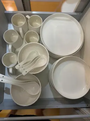 a drawer filled with white plates and utensils at zuvyph in Manila