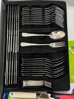 a black container with some silver utensils in it at zuvyph in Manila