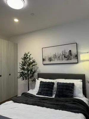 a bedroom with a bed with black and white pillows at zuvyph in Manila