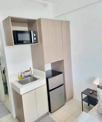 a small kitchen with a sink and a microwave at Erro Place Wi-Fi 200mbps & Netflix in Manila