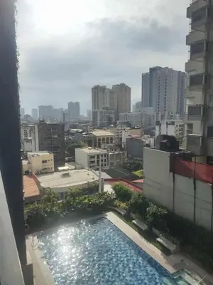 a view of a swimming pool from a building at Red Residences Modern Apartment with City View in Makati in Manila