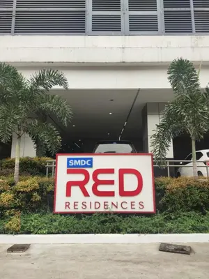 a sign in front of a redresurance at Red Residences Modern Apartment with City View in Makati in Manila