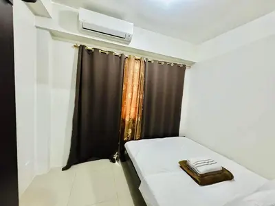 a small room with a bed and a window at Shore 1br shortwalk mall of asia in Manila