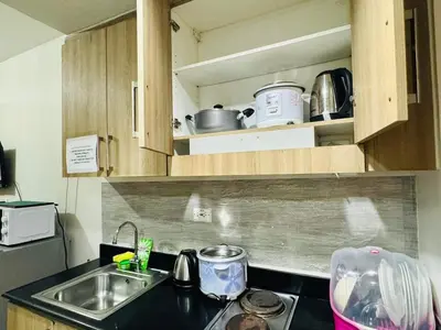 a kitchen with a sink and a counter top at Shore 1br shortwalk mall of asia in Manila