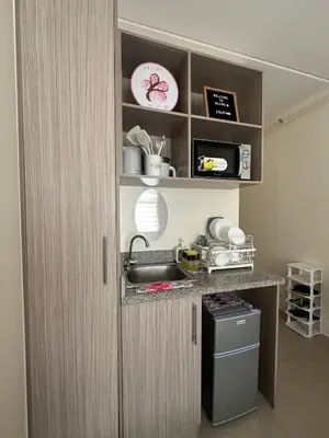 a kitchen with a sink and a counter top at Staycation in Sucat Road in Manila