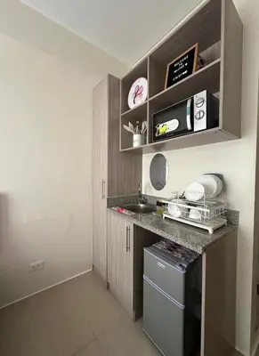a small kitchen with a counter and a sink at Staycation in Sucat Road in Manila