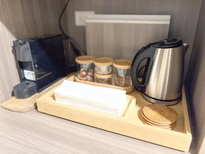 a coffee maker on a wooden tray on a counter at The Luxe Haven at BGC in Sampong