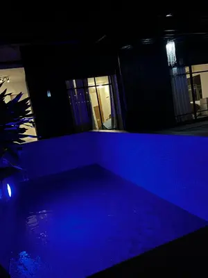 a dark room with a blue light in a building at Boxify Cabins