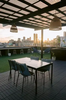 a table and chairs on top of a roof at Canopyproperties in Manila