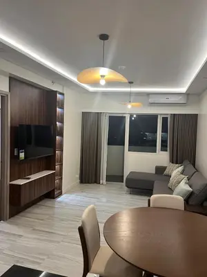a living room with a couch and a table at Cozy Modern Apartment with Luxury Amenities in Manila
