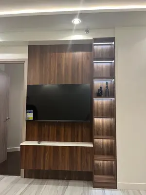 a large entertainment center with a flat screen tv at Cozy Modern Apartment with Luxury Amenities in Manila