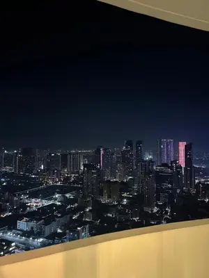 a view of a city skyline at night at Cozy Modern Apartment with Luxury Amenities in Manila