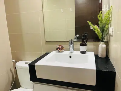 a bathroom with a white sink and a toilet at Venice Luxury Residences Grand Canal View- Tower E in Manila