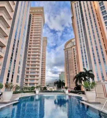a large swimming pool in front of tall buildings at Venice Luxury Residences Grand Canal View- Tower E in Manila