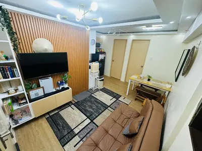 a living room with a couch and a flat screen tv at 17th Casa Horizon in Manila