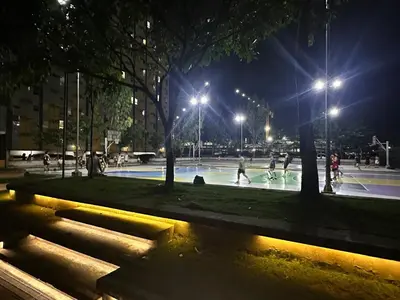 a group of people playing basketball at night at 17th Casa Horizon in Manila