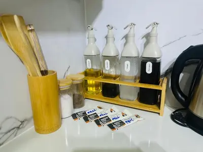 a counter with a group of bottles on a shelf at 17th Casa Horizon in Manila