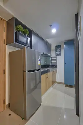 a kitchen with a stainless steel refrigerator and a microwave at Modern Loft-Style Condo - Perfect for Families or Couples in Manila