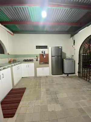 a kitchen with a stainless steel refrigerator in a room at Big Beautiful House in Pasig in Manila