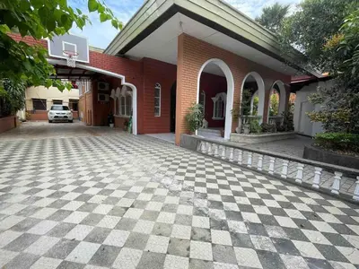 a brick house with a checkered driveway in front of it at Big Beautiful House in Pasig in Manila
