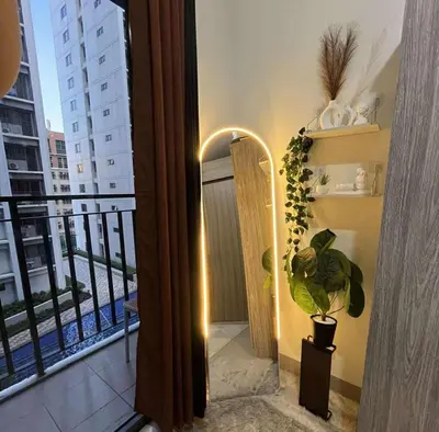 a room with a balcony with a view of a building at Cozy Haven in Manila