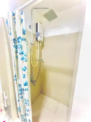 a shower in a bathroom with a shower curtain at 1 bedroom near MOA NAIA with parking slot included pls send valid ids of guests after booking in Manila