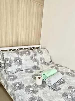 a bed with towels and a toilet paper on it at 1 bedroom near MOA NAIA with parking slot included pls send valid ids of guests after booking in Manila