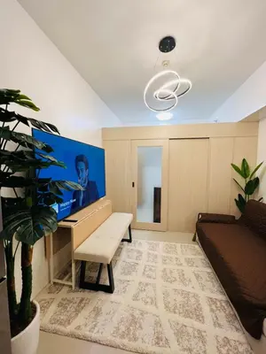 a living room with a desk and a couch at Sarah's Place at Light Residences in Manila