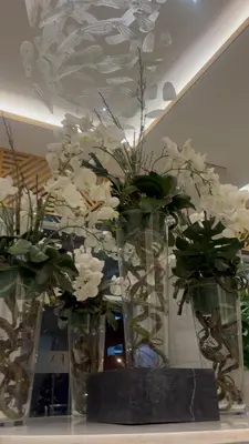 three vases filled with white flowers on a table at CitySoul in Manila