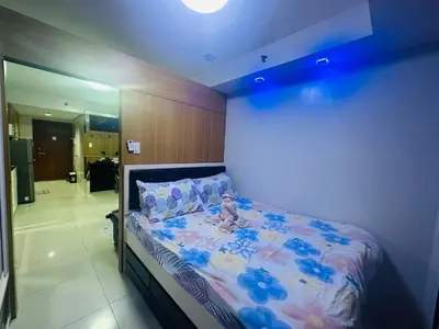 a bedroom with a bed with a teddy bear on it at Ritzy Pasay Getaway - Entire Apartment for Rent in Manila