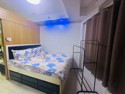 a small bedroom with a bed in a room at Ritzy Pasay Getaway - Entire Apartment for Rent in Manila