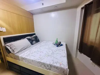 a small bed in a small room with at Ritzy Pasay Getaway - Entire Apartment for Rent in Manila