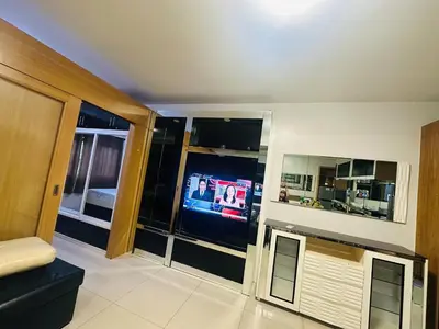 a living room with a tv in a room at Ritzy Pasay Getaway - Entire Apartment for Rent in Manila