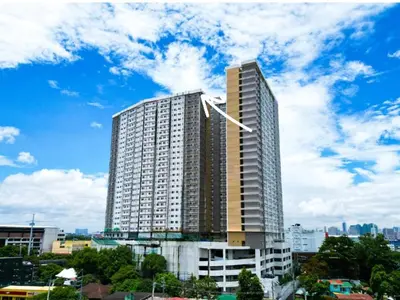 a tall building in a city with a cloudy sky at 2 BR Penthouse with Sunset View in Manila