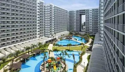 an overhead view of a large swimming pool with tall buildings at Elegant Pasay City Apartment with Central Heating Shared Pool in Manila