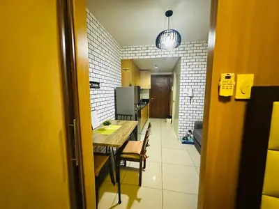 a kitchen and dining room with a table and chairs at Simple Pasay Getaway - Entire Apartment for Rent in Manila