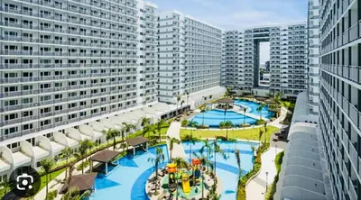 an aerial view of a resort with two pools at Simple Pasay Getaway - Entire Apartment for Rent in Manila