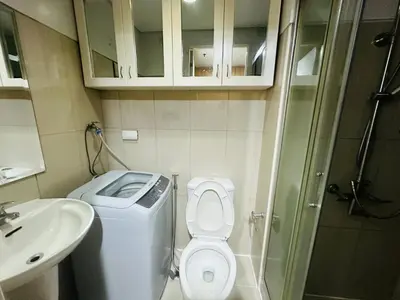 a small bathroom with a toilet and a sink at Ultra Pasay City Apartment for Rent - Perfect for Short-Term Stay Front of MOA in Manila