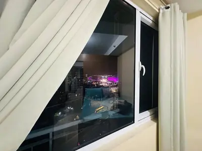 a window with a view of a city at Timeless Pasay City Apartment for Rent in Manila
