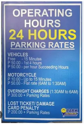 a sign that says operating hours and hours parking rates at Timeless Pasay City Apartment for Rent in Manila