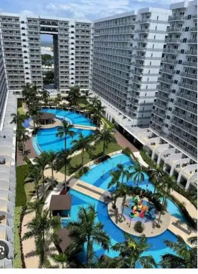 an aerial view of the pools at a resort at Gentle Pasay City Apartment for Rent - Perfect Family Getaway Near Mall of Asia in Manila