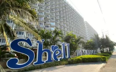 a large building with a sign in front of it at Happy 1br Pasay Apartment for Rent -Peaceful Oasis in the City near Mall Of Asia in Manila