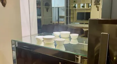 a glass counter with white cups on top of it at Yare Pasay City Apartment for Rent Perfect for Stay front of Mall of Asia in Manila